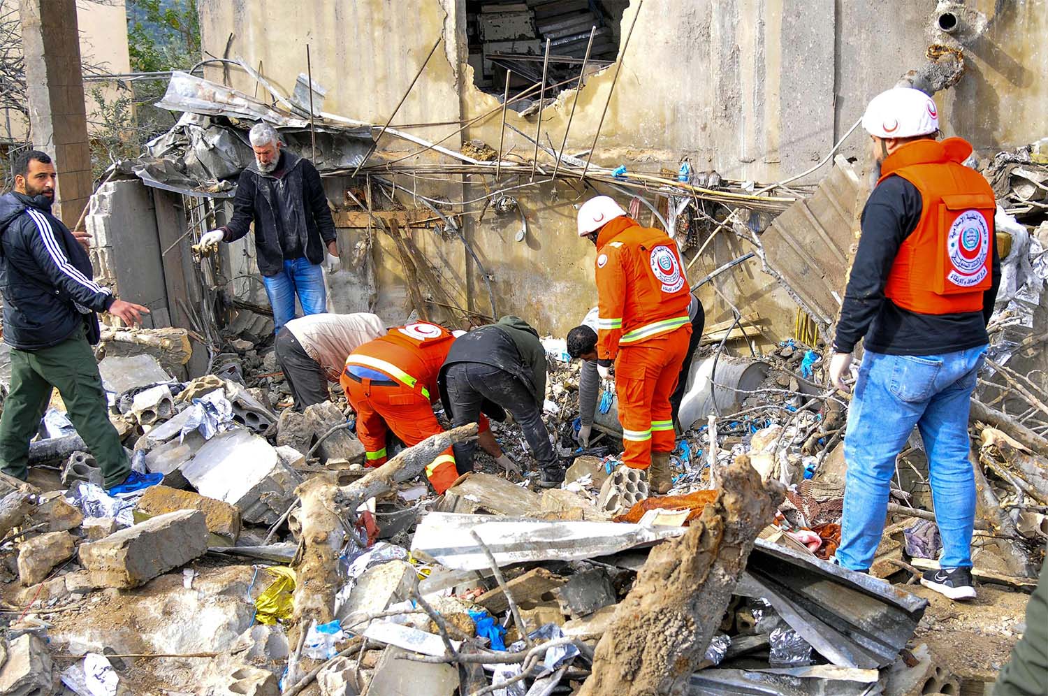 People inspect destruction at the site of an overnight Israeli airstrike in Habariyeh