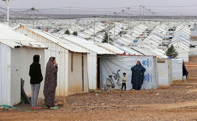 Syrian refugee women stand in front of their homes at Azraq refugee camp, near Al Azraq city, Jordan