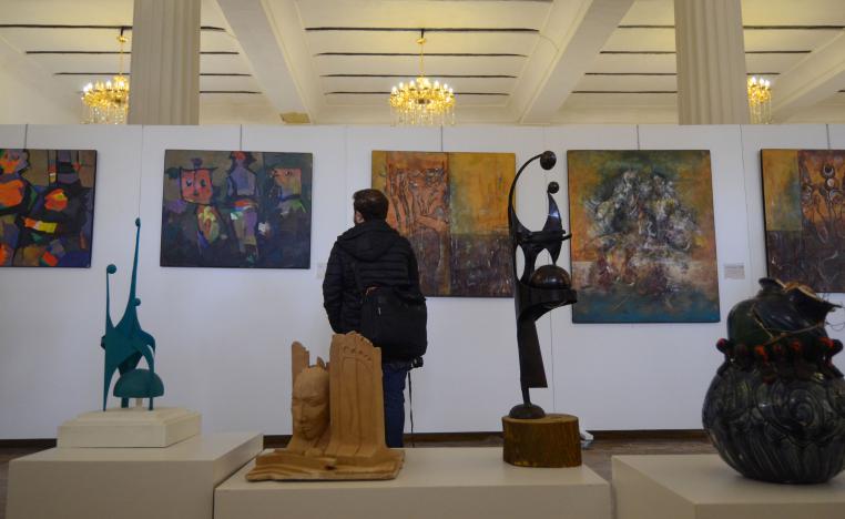 An Iraqi man looks at paintings on January 29, 2019 at a contemporary art exhibition at one of the halls of the national museum of the northern Iraqi city of Mosul.