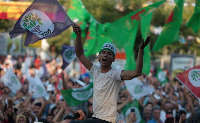 A supporter of the pro-Kurdish Peoples' Democratic Party (HDP) waves a party flag during a peace day rally in Diyarbakir