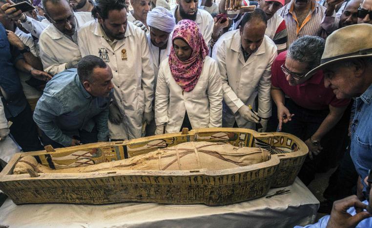 Egyptian officials and archaeologists surround a sarcophagus belonging to a man in front Hatshepsut Temple at Valley of the Kings in Luxor