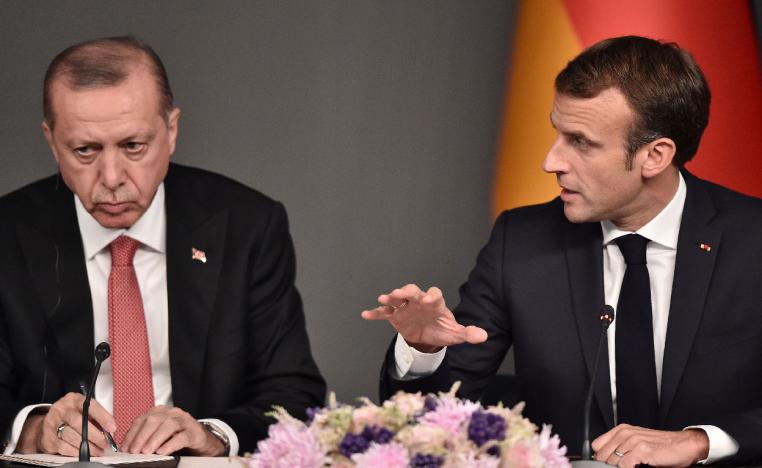Turkish President Recep Tayyip Erdogan (L) listens to France's President Emmanuel Macron