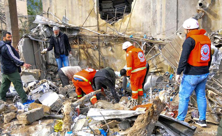 People inspect destruction at the site of an overnight Israeli airstrike in Habariyeh