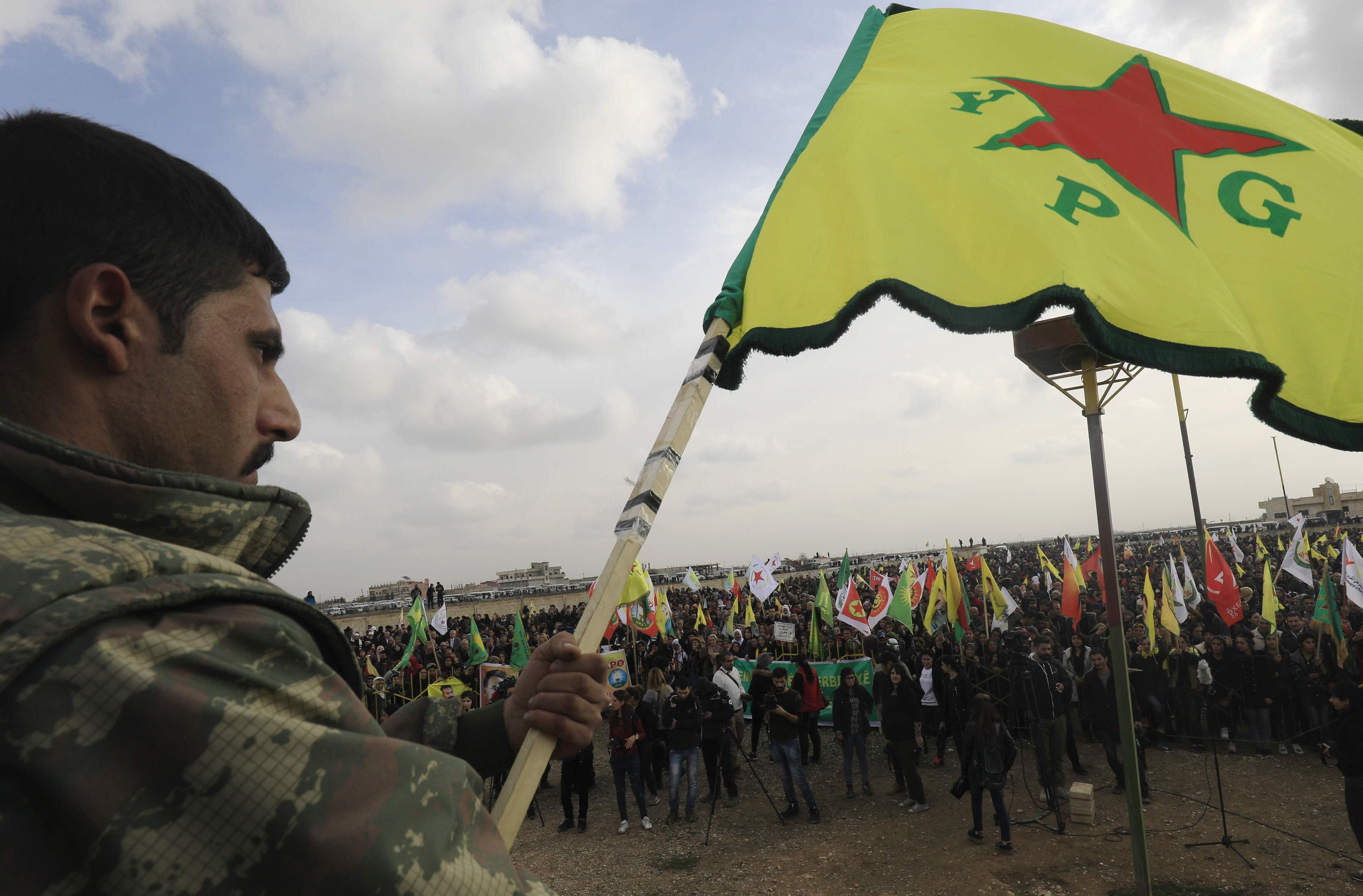 جندي كري يرفع علم الأكراد في سوريا