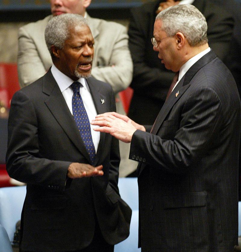 A 2003 file picture shows UN Secretary-General Kofi Annan (L) and US Secretary of State Colin Powell talking prior to the start of a UN Security Council on the situation in Iraq