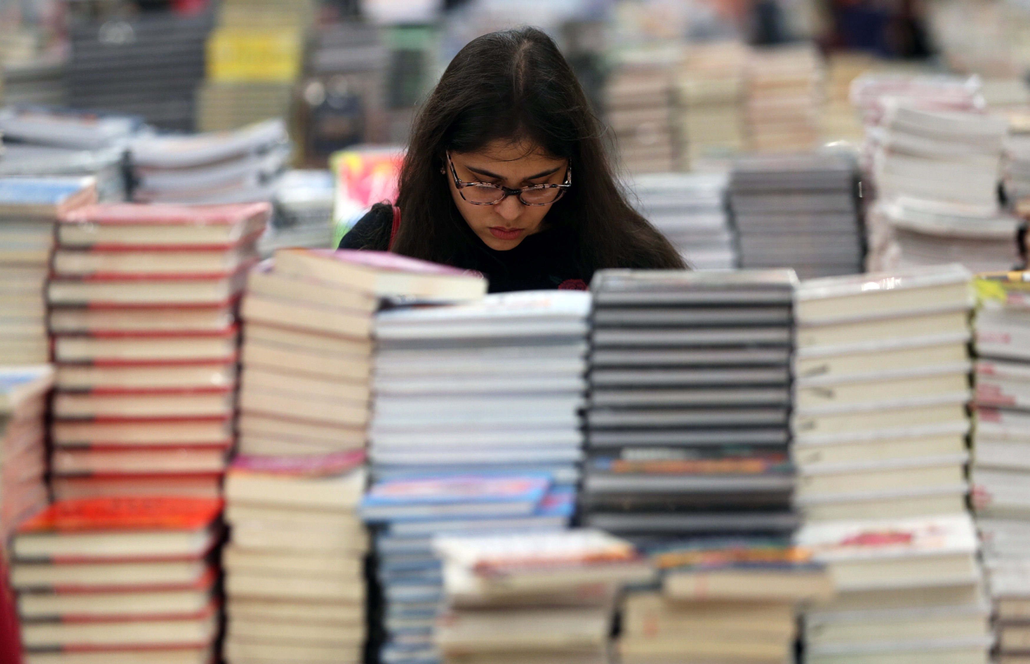 A visitor reads a book at the Big Bad Wolf Book Sale.
