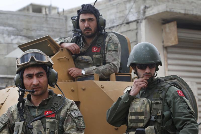 Turkish soldiers atop an armoured personnel carrier secure the streets of the north-western city of Afrin, last March