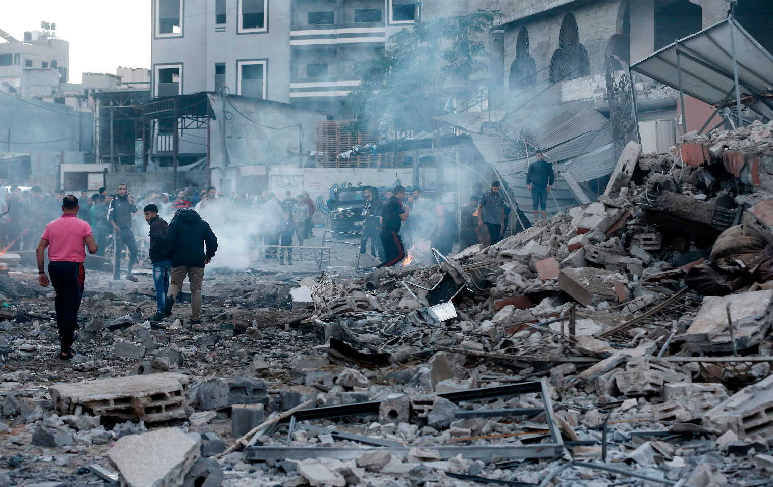 People inspect the rubble of a building following an Israeli air strike on Gaza City on October 27, 2018.