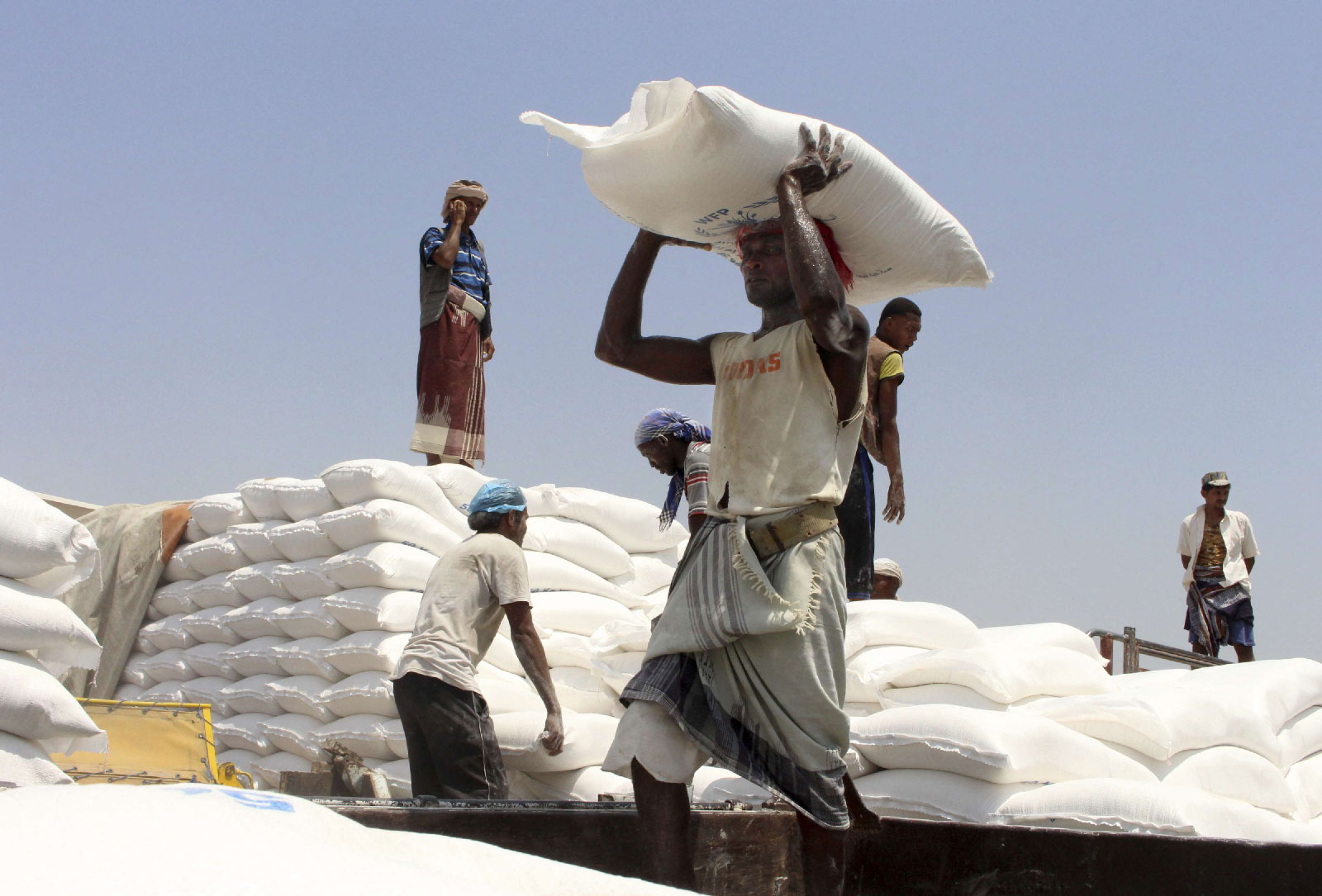 Men deliver UN World Food Programme (WFP) aid in Hajjah, Yemen.