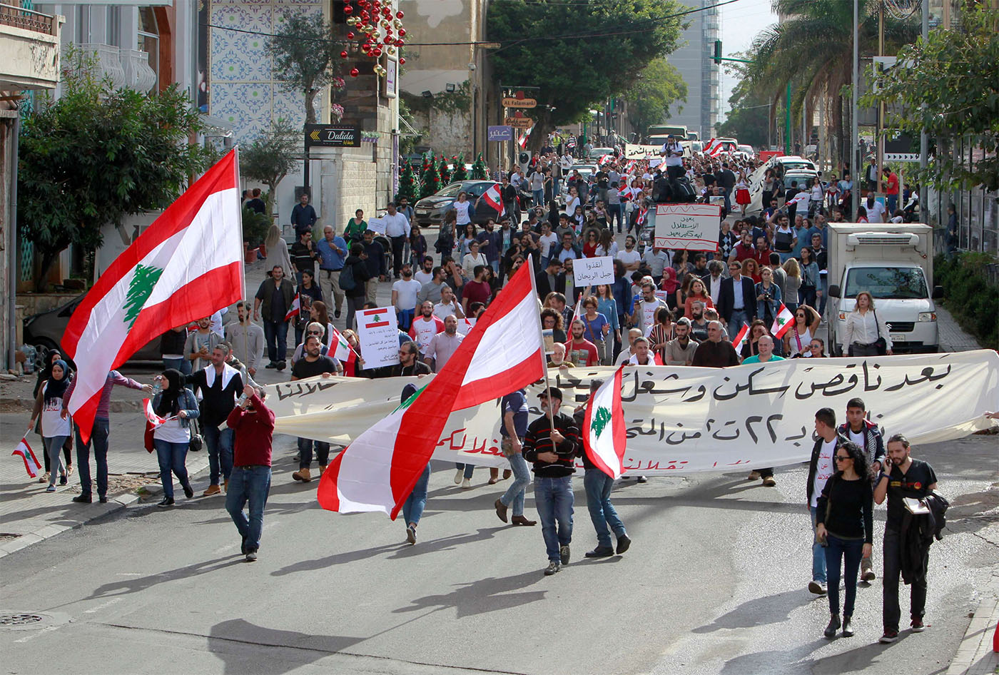 Protesters hold banners and Lebanese flags in Beirut