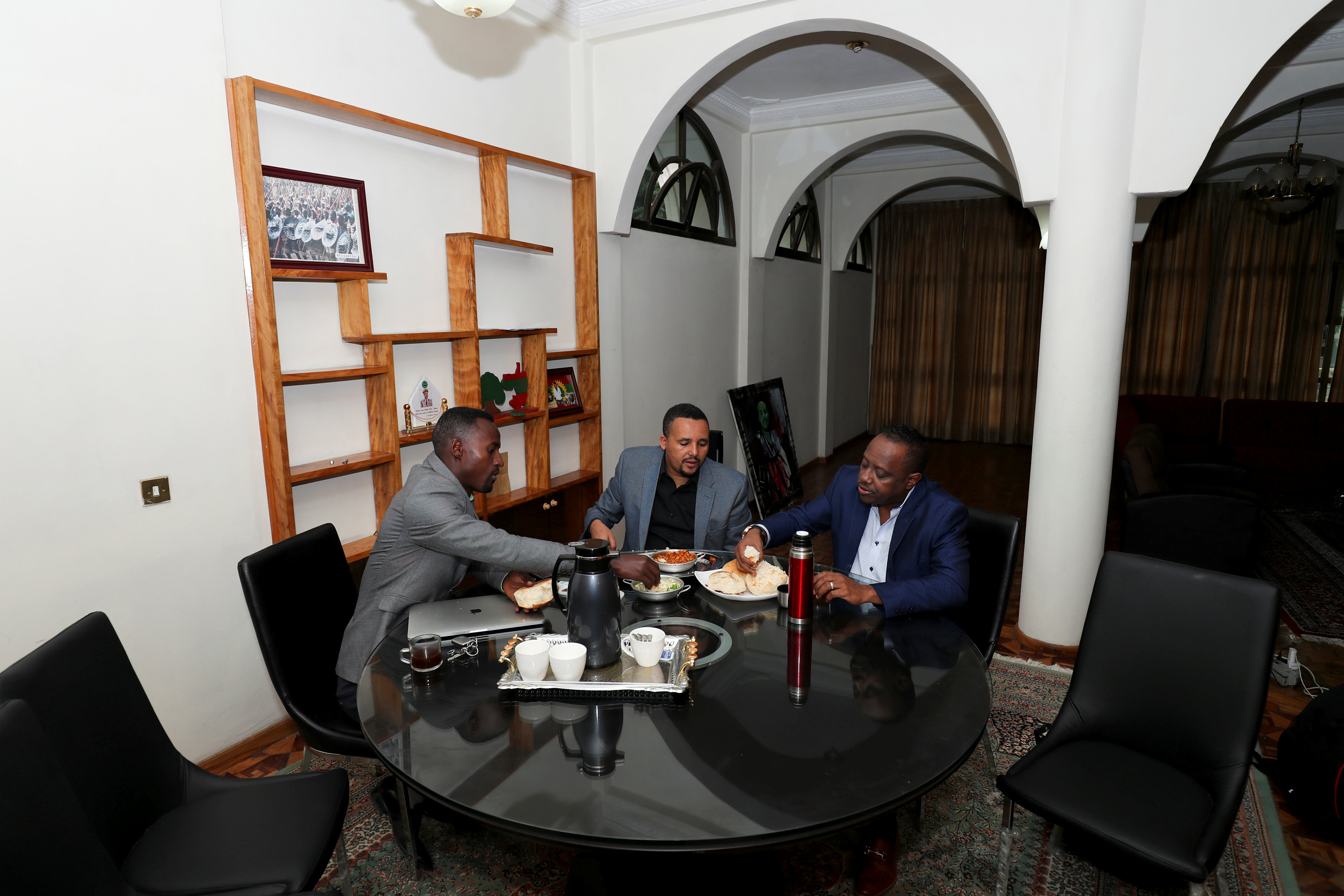 Jawar Mohammed (C), 32, eats breakfast with his colleagues at his house in Addis Ababa.