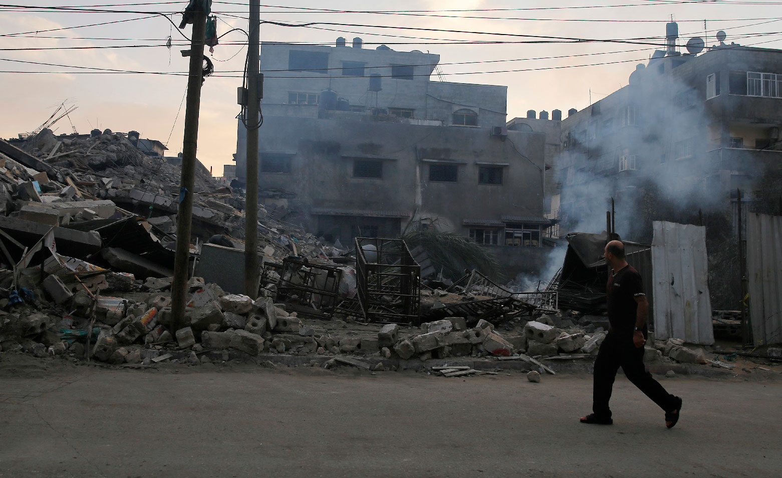 Smoke rises from a residential building that was hit by Israeli airstrikes, in Gaza City, Tuesday, Nov. 13, 2018.