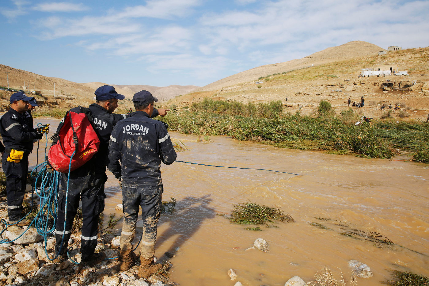 Civil defense members look for missing persons after rain storms unleashed flash floods, in Madaba city, near Amman, Jordan, November 10, 2018.