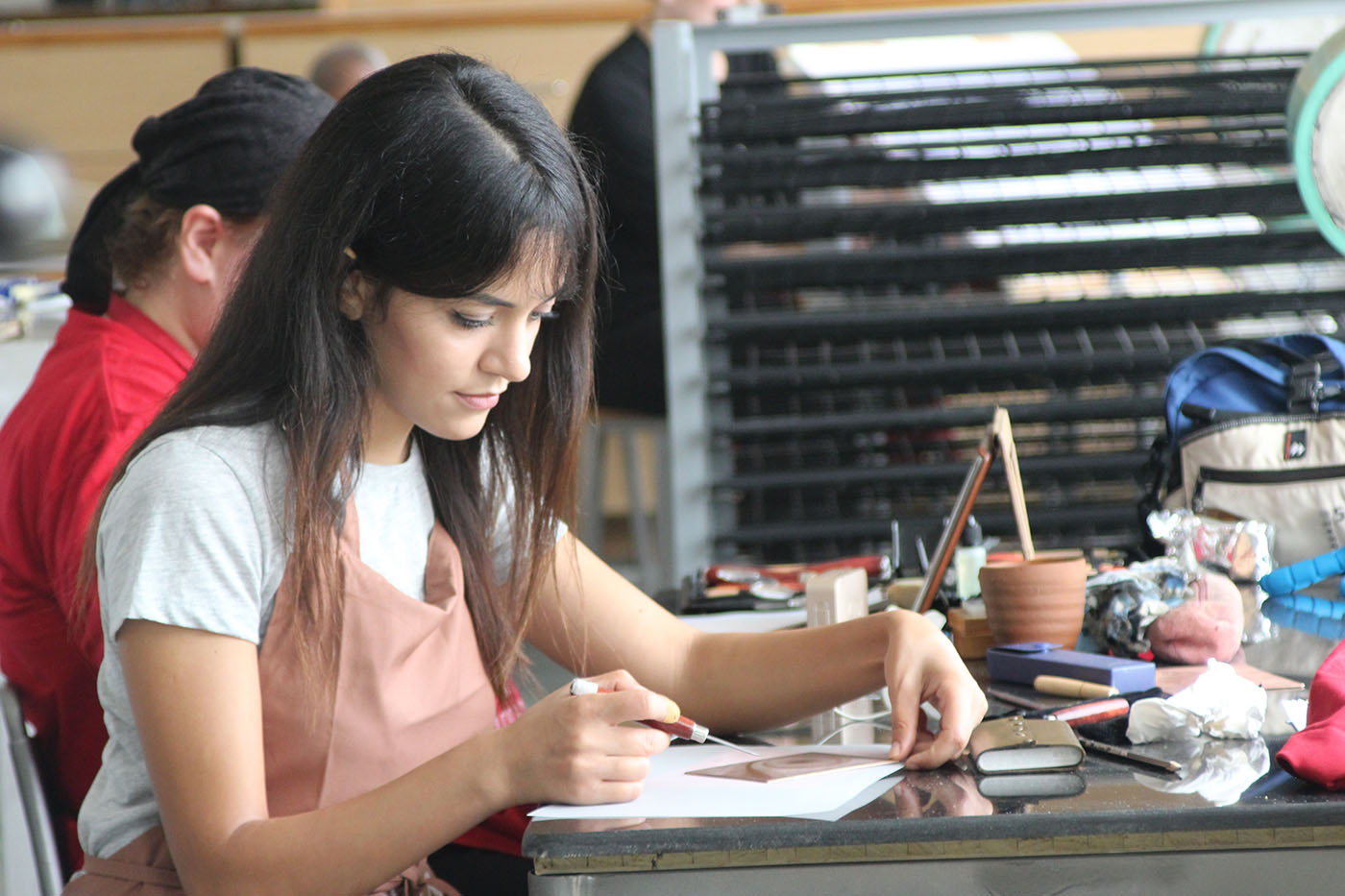 Artist Oumayma Badoud working on her engravings in the workshop