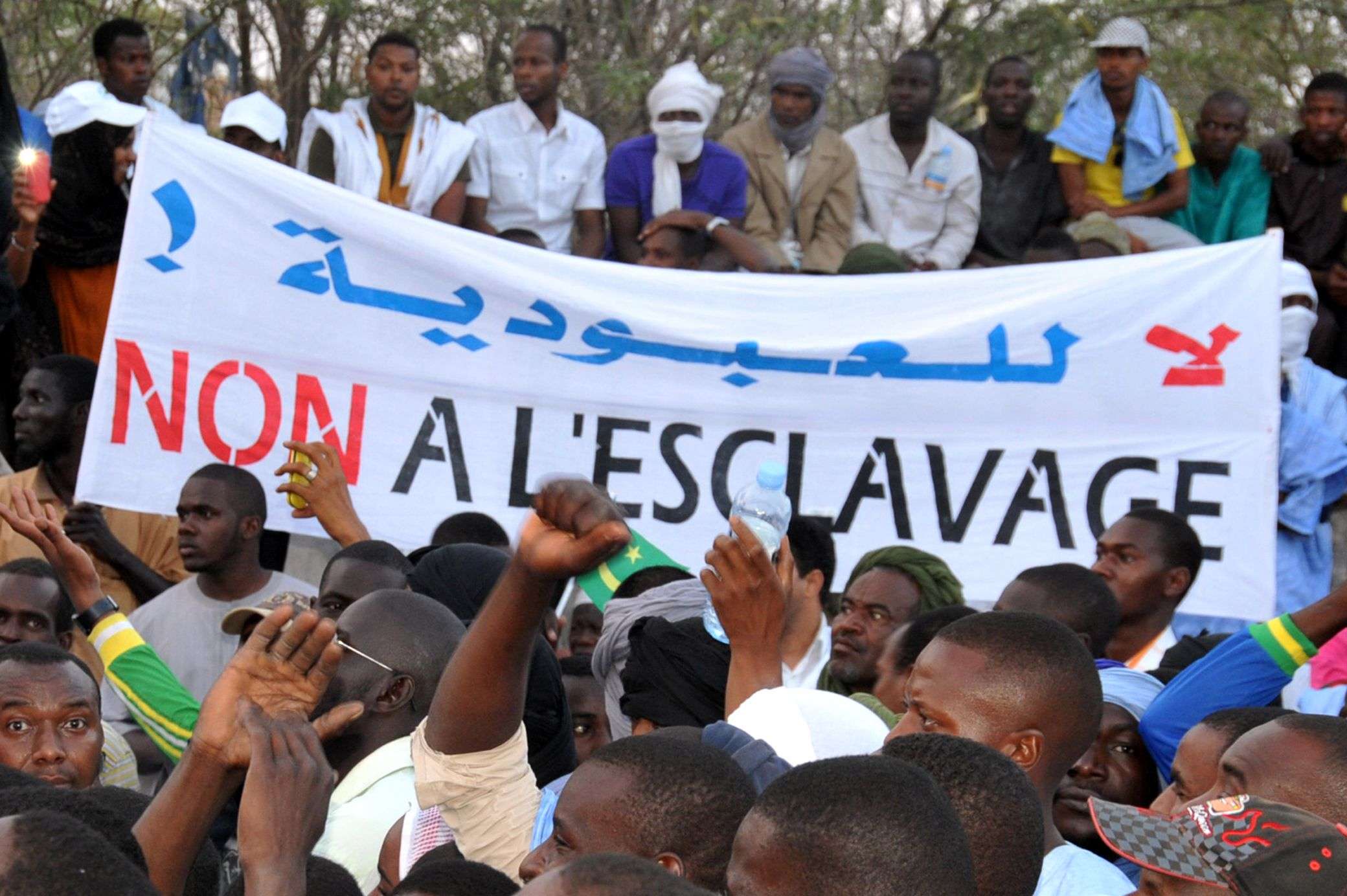 People holding a banner reading "No to slavery" during a demonstration against discrimination in Nouakchott, Mauritania.