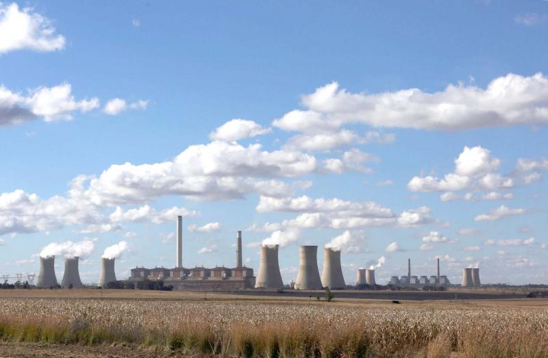 Open to debate. Smoke rises from the cooling towers of the Matla Power Station, a coal-fired power plant in South Africa.