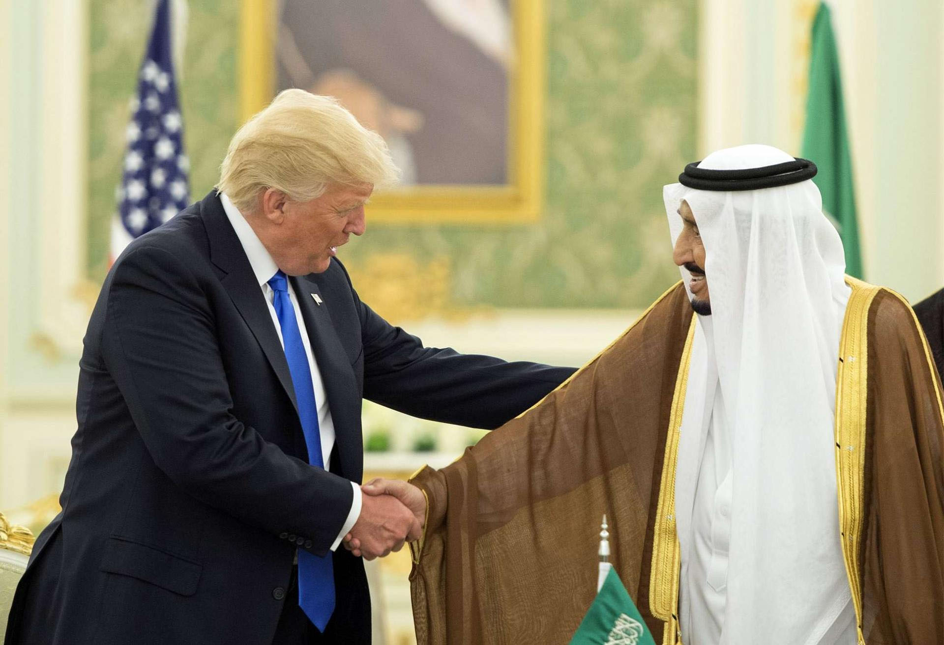 Saudi King Salman shakes hands with US President Donald Trump