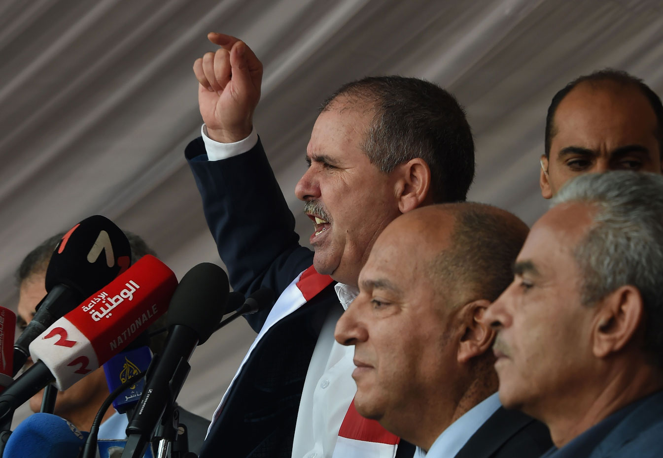 General Secretary of the Tunisian General Labour Union (UGTT) Noureddine Taboubi (C) gives a speech during a civil servants strike in the capital Tunis on November 22, 2018.