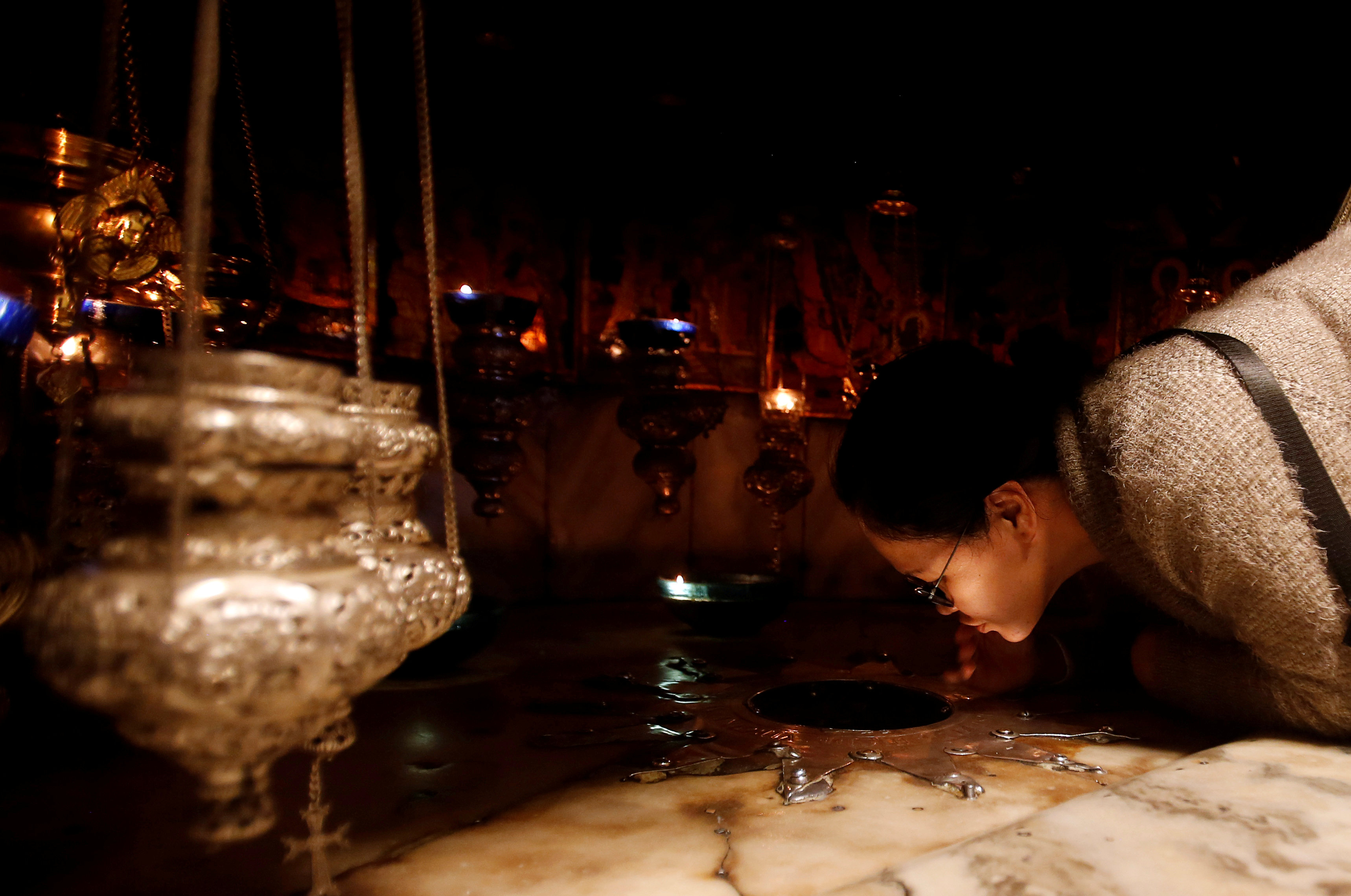 A worshipper kisses the star inside the cave at the Church of the Nativity, in Bethlehem in the Israeli-occupied West Bank December 23, 2018.