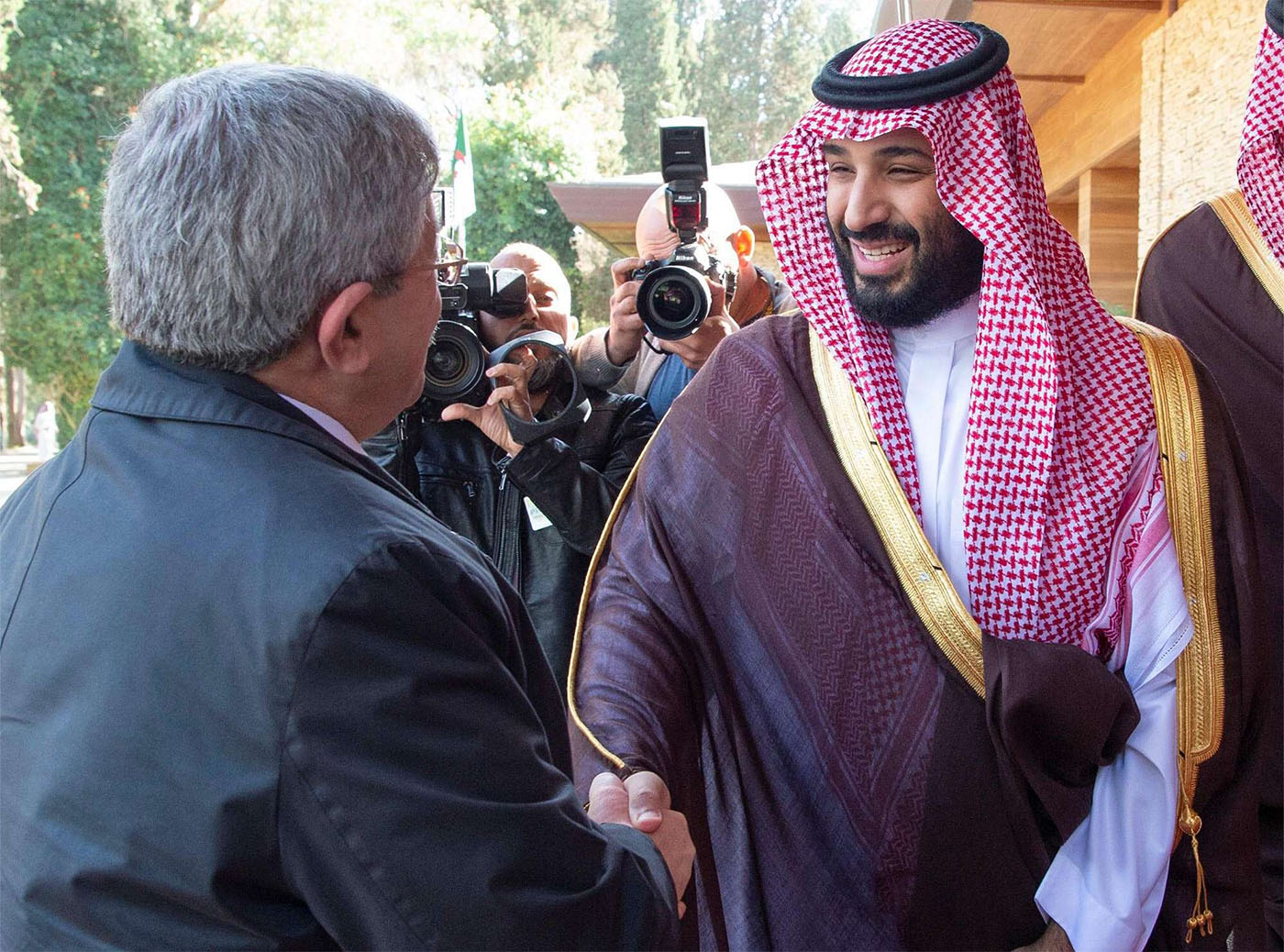 Saudi Arabia's Crown Prince Mohammed bin Salman Al Saud (R) shakes hands with Algerian PM Ahmed Ouyahia