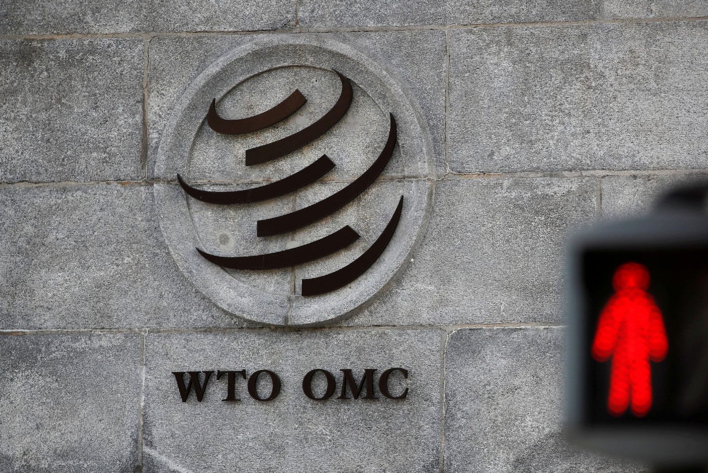 A logo is pictured outside the World Trade Organization (WTO) headquarters next to a red traffic light in Geneva, Switzerland, October 2, 2018. 