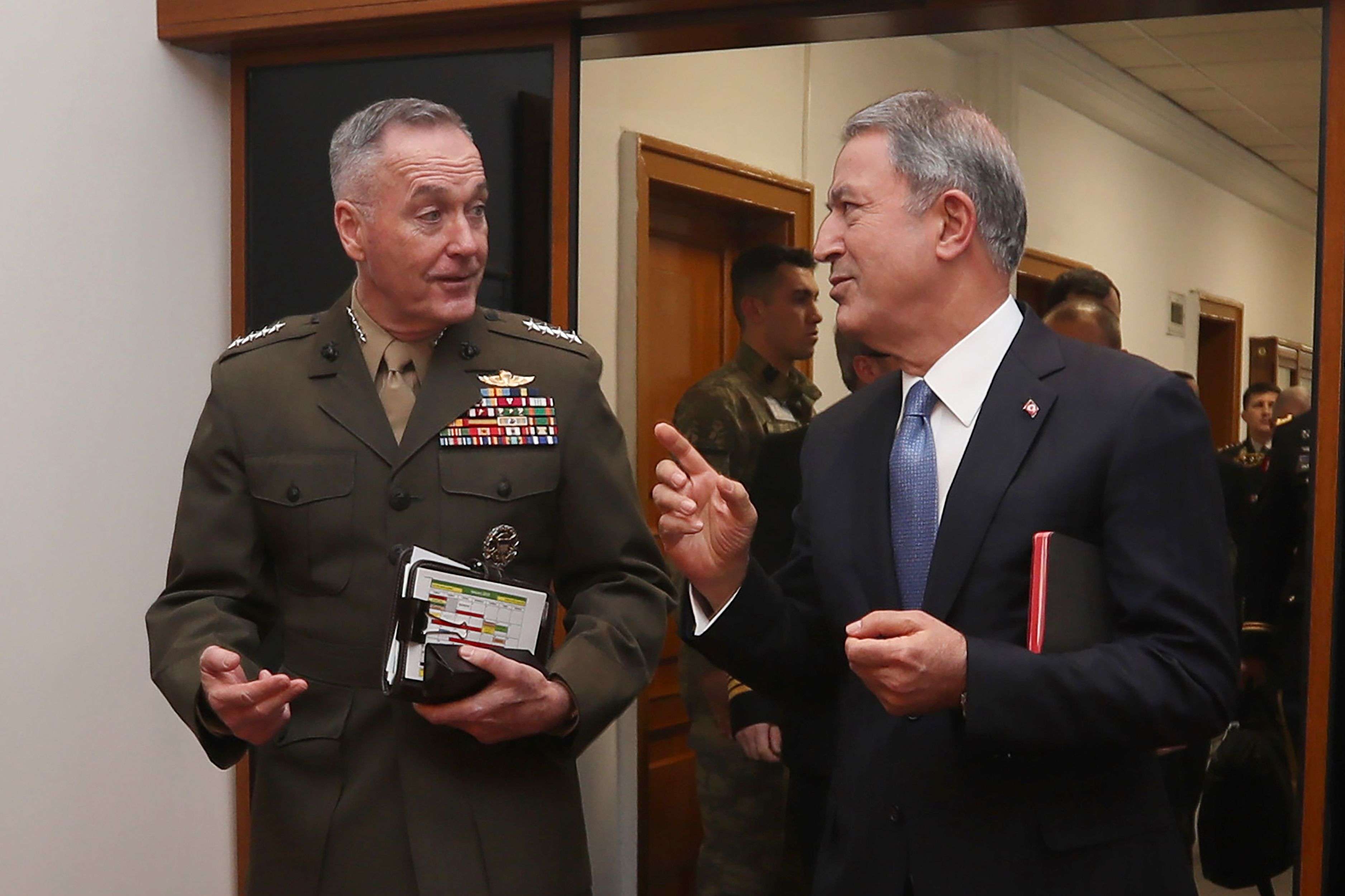 Turkish Defence Minister Hulusi Akar (R) and US Chairman of the Joint Chiefs of Staff Joseph Dunford speak during a meeting in Ankara on January 8, 2019.