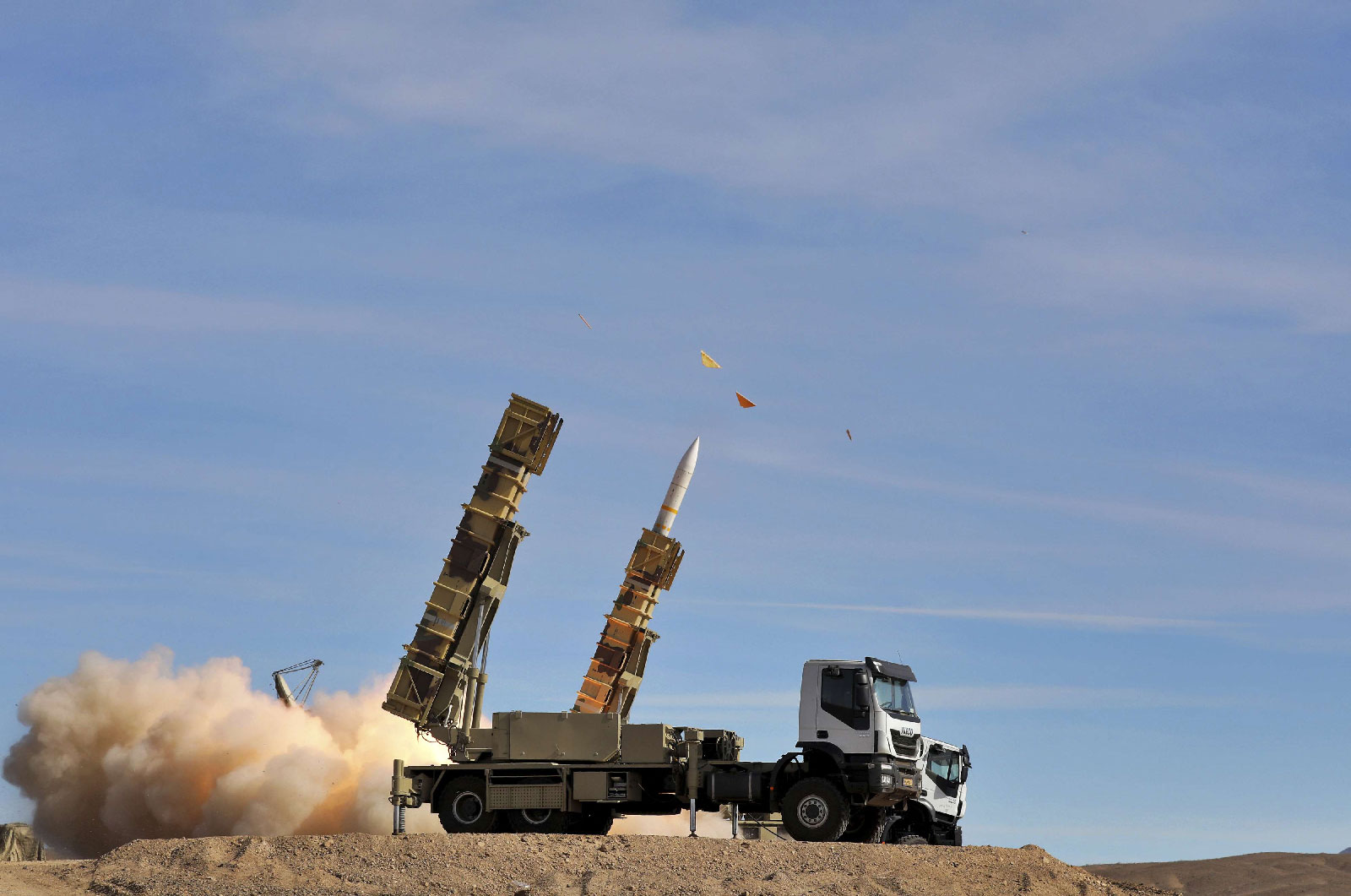 In this photo provided Monday, Nov. 5, 2018, by the Iranian Army, a Sayyad 2 missile is fired by the Talash air defense system during drills in an undisclosed location in Iran.