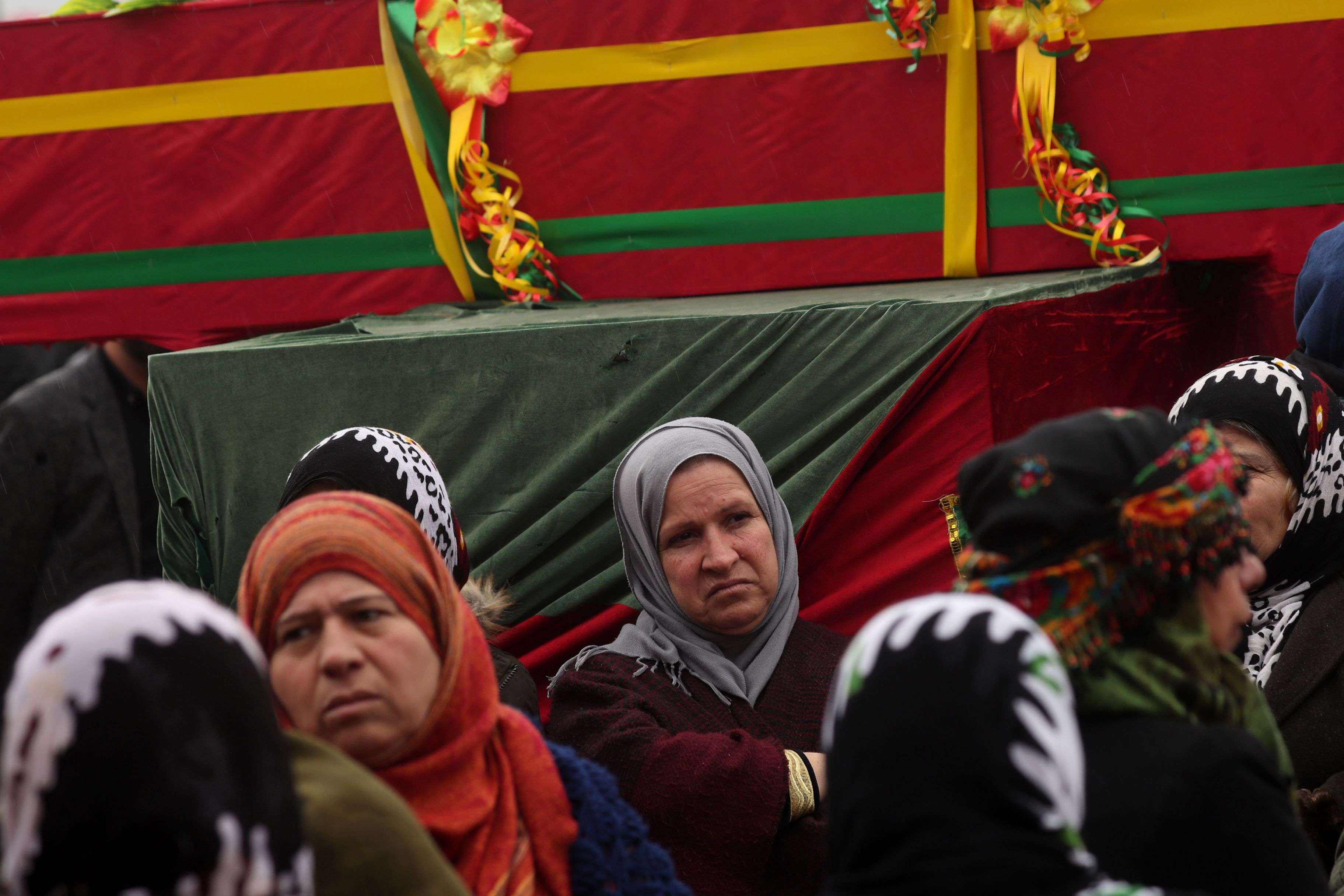 Mourners surround the coffin of a local official, who fighters from the Syrian Democratic Forces (SDF) say was assassinated in a Kurdish-held area in the countryside of Deir Ezzor, during his funeral in northeastern Syrian Kurdish-majority city of Qamishli, on December 31, 2018.