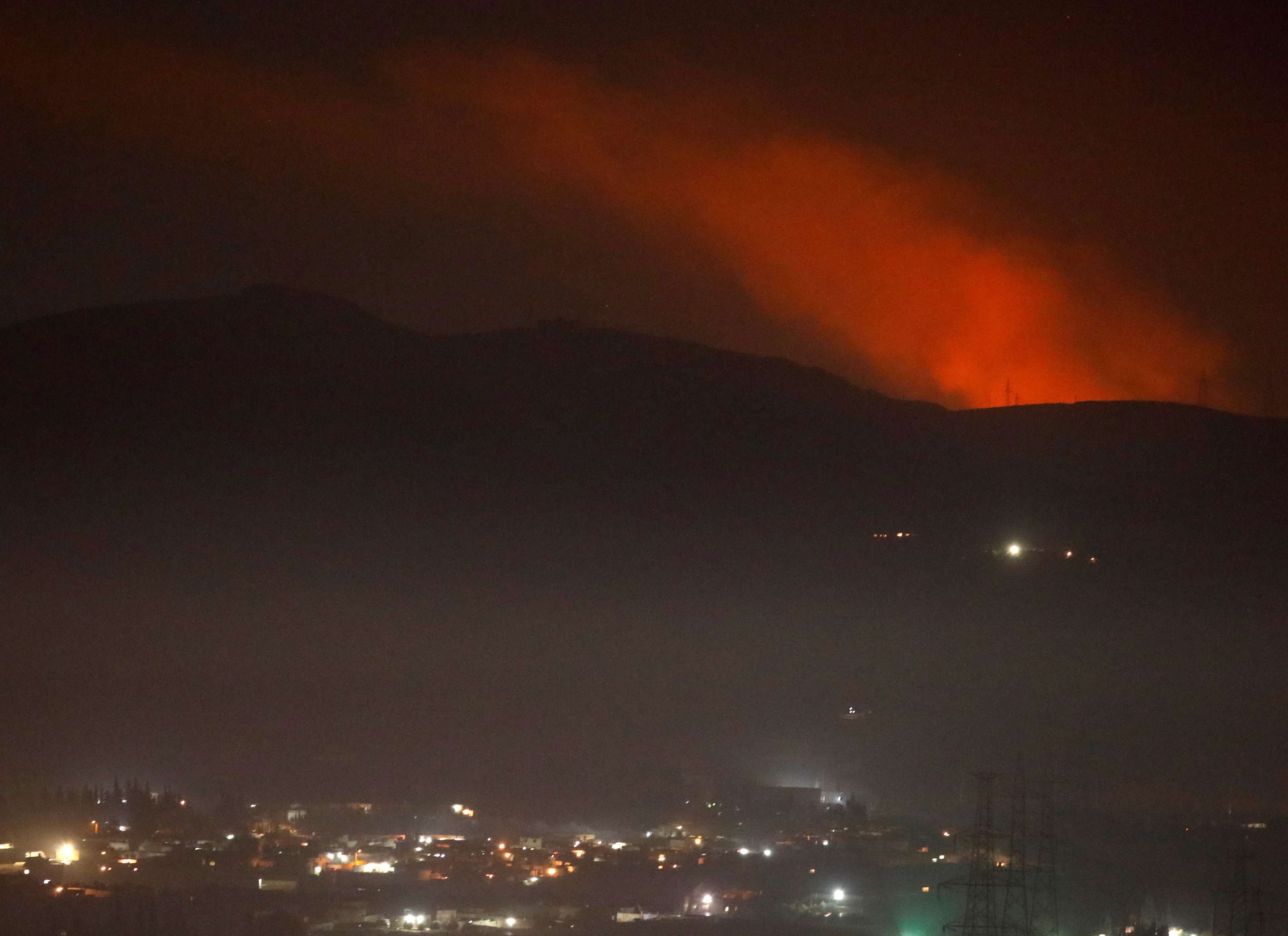 Smoke rises past a mountain as seen from Damascus countryside, Syria December 25, 2018.