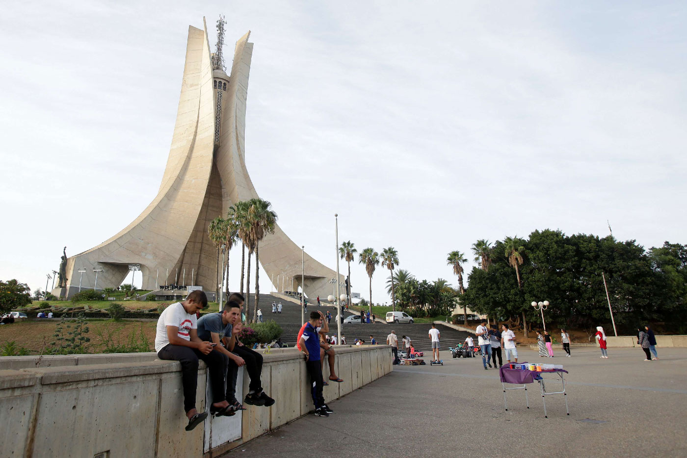 Youths sit near the Martyrs' Memorial in Algiers, Algeria September 10, 2018.