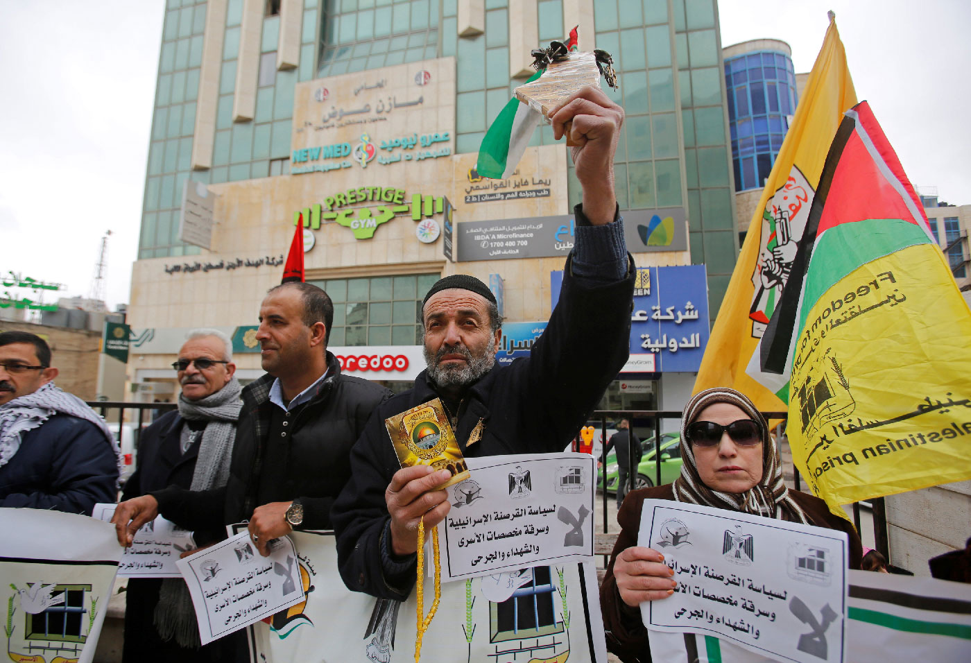 A Palestinian demonstrator holding a copy of Koran takes part in a protest against an Israeli decision to trim funds over prisoner stipends, in Hebron, in the Israeli-occupied West Bank, February 19, 2019.