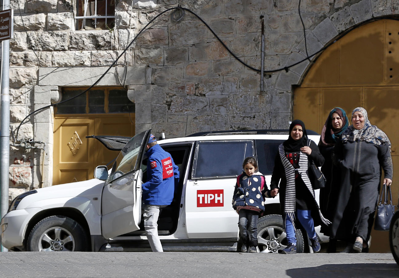 Palestinian Territories, Hebron: A Member of the Temporary International Presence in Hebron, (TIPH), gets in one of the organization's vehicles during a tour by the organization in the West Bank on 31 January 2019.