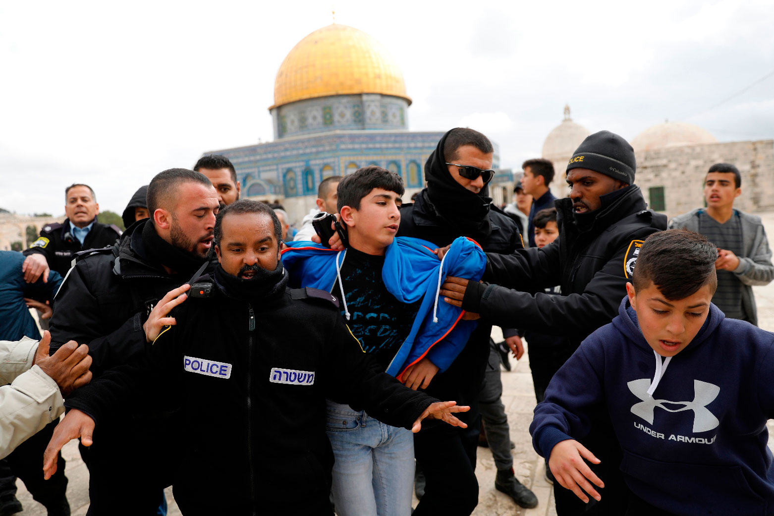 Israeli policemen detain a young Palestinian demonstrator during clashes, after protesters tried to break the lock on a gate at the Al Aqsa mosque compound in Jerusalem's Old City on February 18, 2019, after it was closed by Israeli police.
