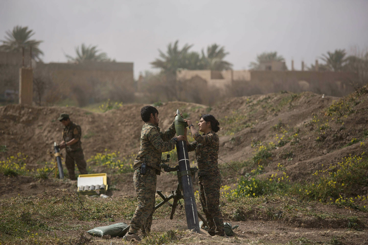 U.S.-backed Syrian Democratic Forces (SDF) soldiers prepare to fire mortars at Islamic State militant positions in Baghouz, Syria, Wednesday, March 13, 2019.