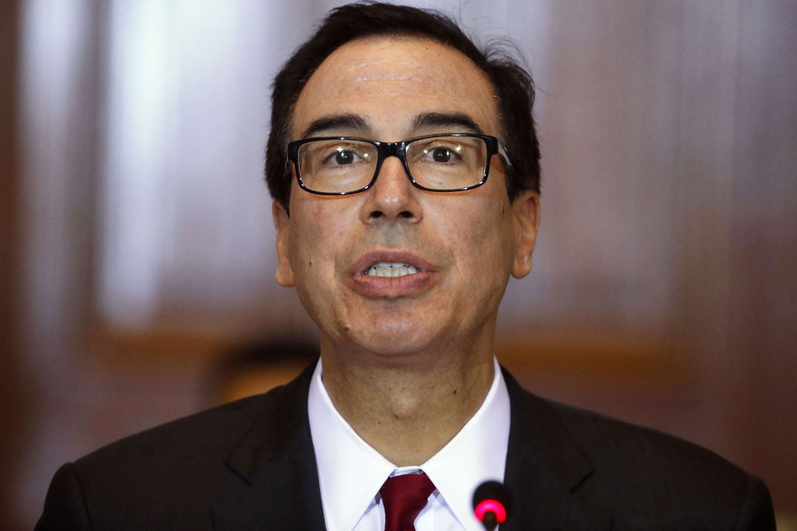 In this Oct. 16, 2018, photo Treasury Secretary Steve Mnuchin leads a meeting of the Financial Stability Oversight Council at the Treasury Department in Washington.