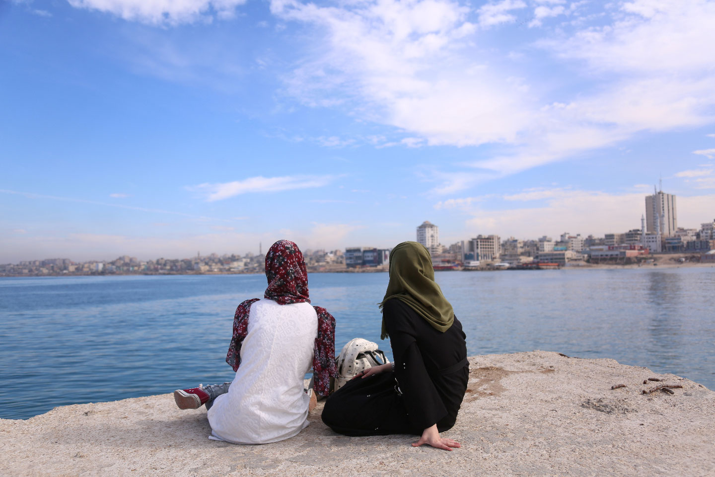 Palestinian Sara Abu Taqea (R), 23, who works in the maternity ward at Gaza's Al-Ahli hospital, and her friend spend time at the seaport in Gaza City, November 27, 2018.