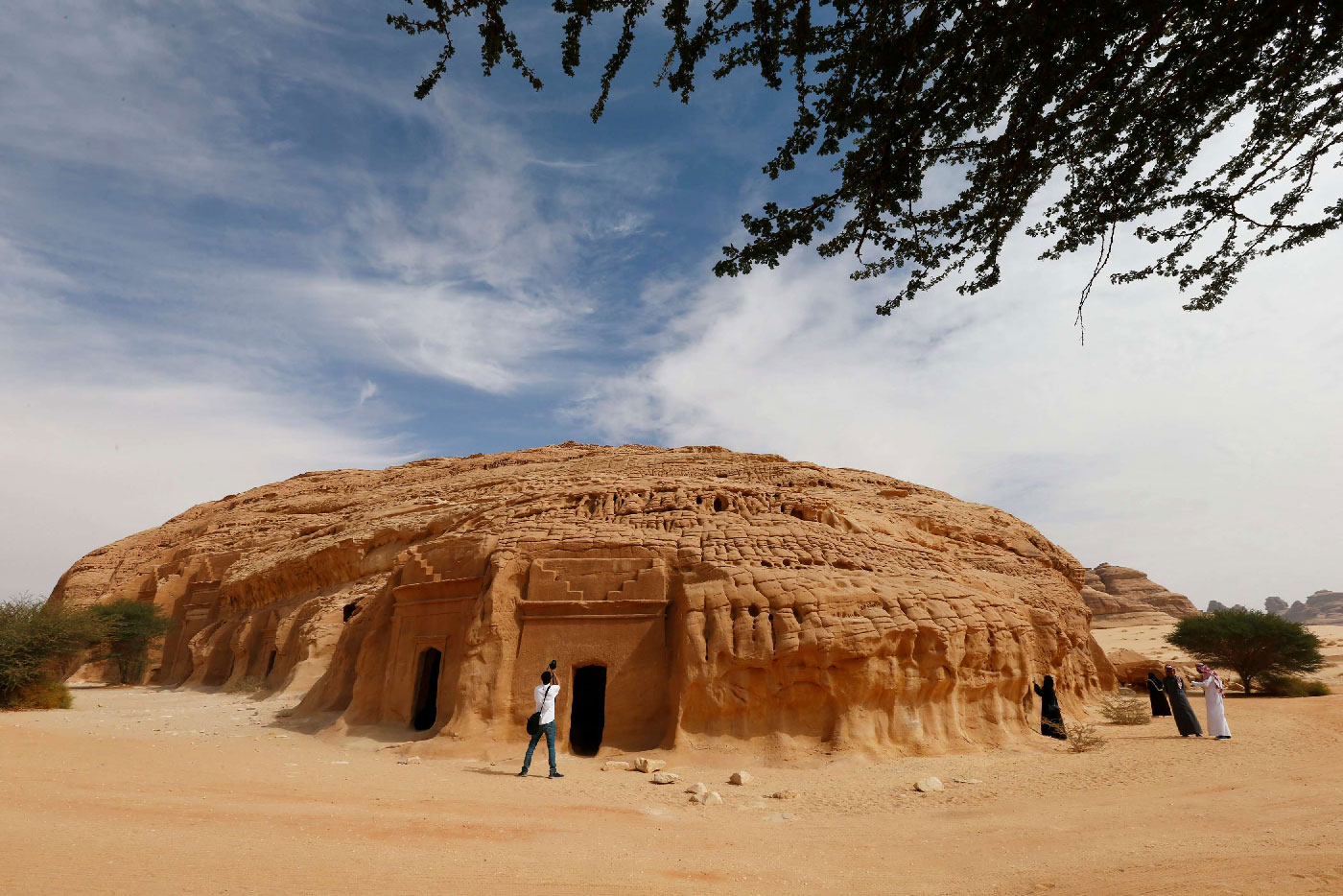 Visitors take pictures at majestic rock-hewn tombs of Madain Saleh near the city al-Ula, Saudi Arabia January 25, 2019. 