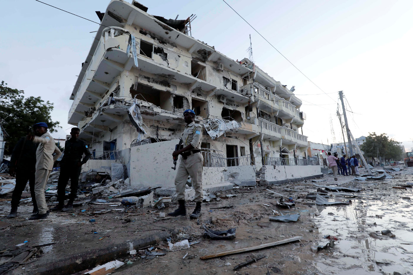 Security forces walk through rubble near damaged buildings after a suicide car bomb exploded, targeting a hotel in a business center in Maka Al Mukaram street, Mogadishu, Somalia March 1, 2019.