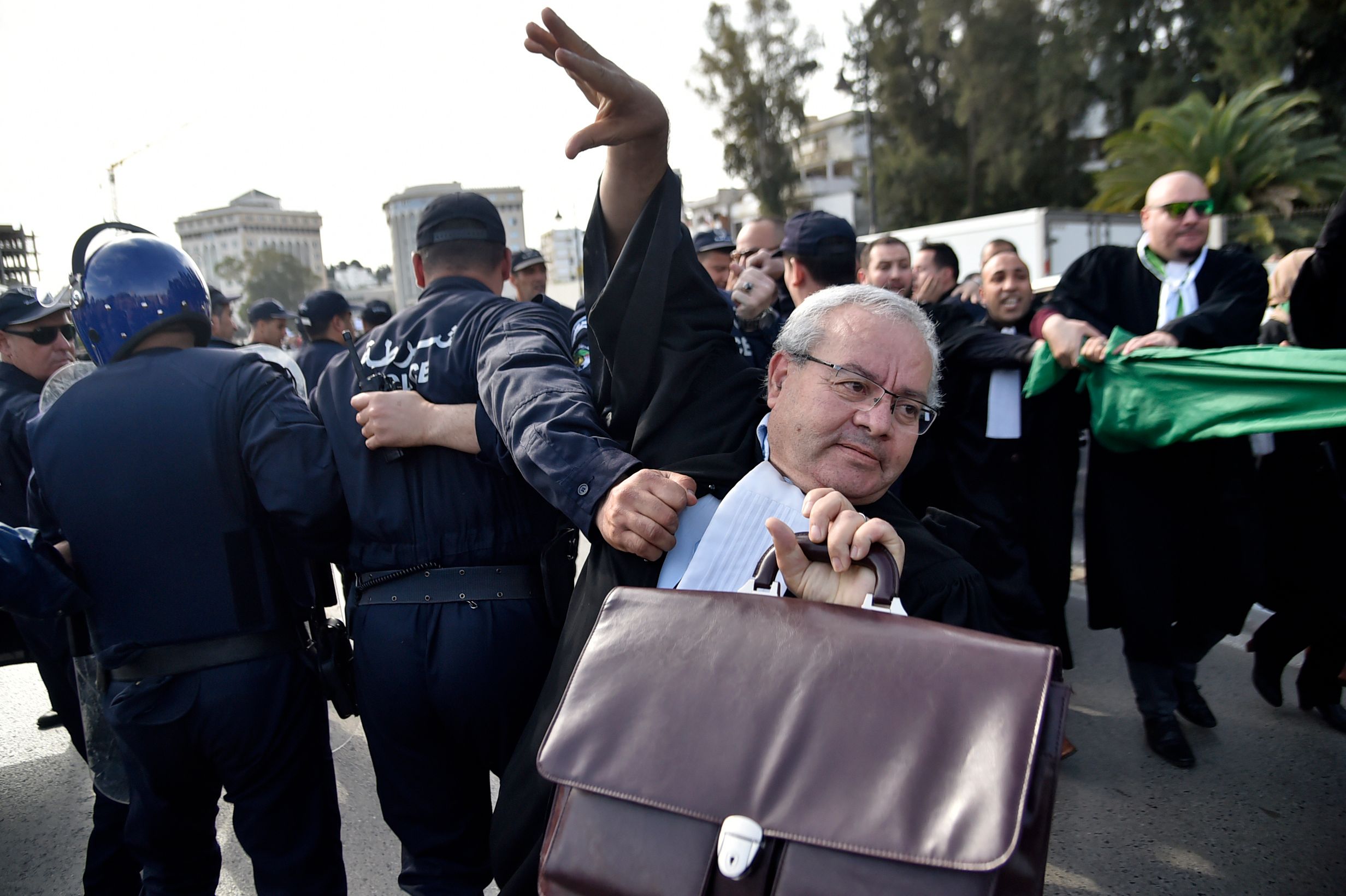 Algerian police disperse a protest by lawyers and journalists against their ailing president's bid for a fifth term in power, in Algiers on March 7, 2019.