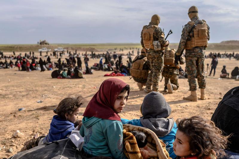 Civilians evacuated from the ISIS holdout of Baghouz wait at a screening area in the eastern Syrian province of Deir ez-Zor, March 5