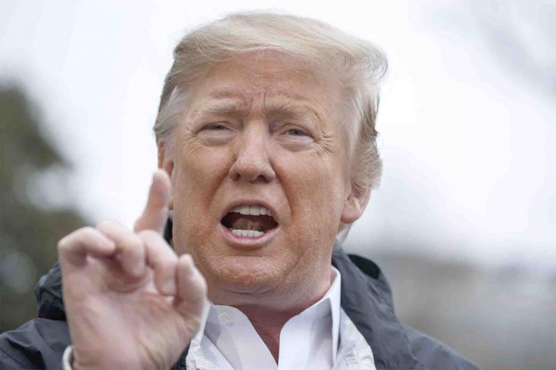  US President Donald Trump talks with reporters outside the White House in Washington