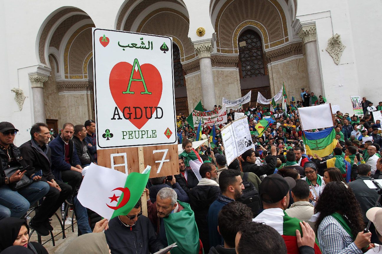 Protesters wave national flags and banners in Algiers
