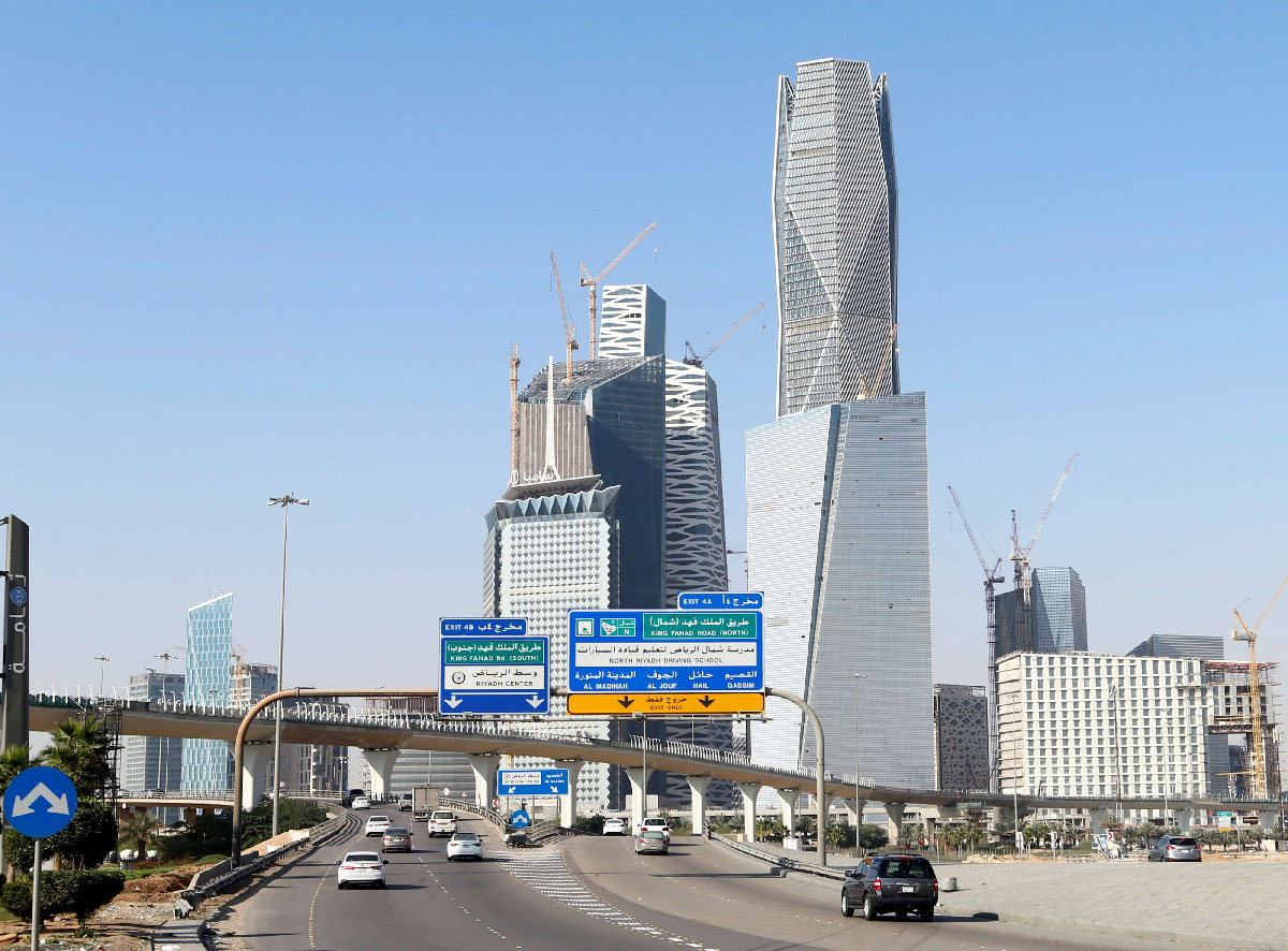Cars drive past the King Abdullah Financial District in Riyadh