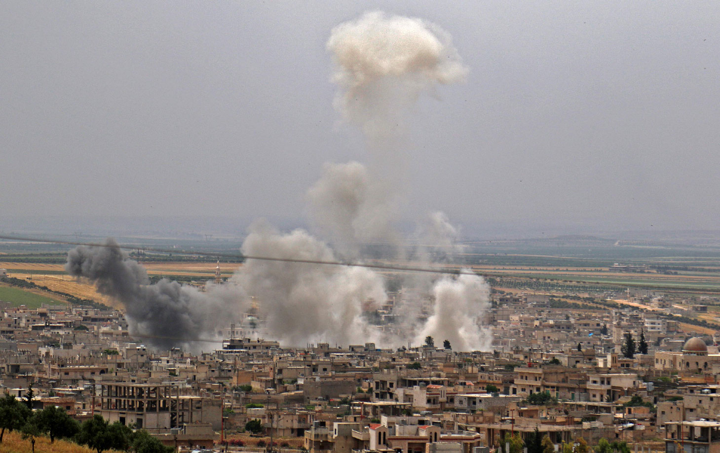 Smoke plumes rising following reported Syrian government forces' bombardment on the town of Khan Sheikhun