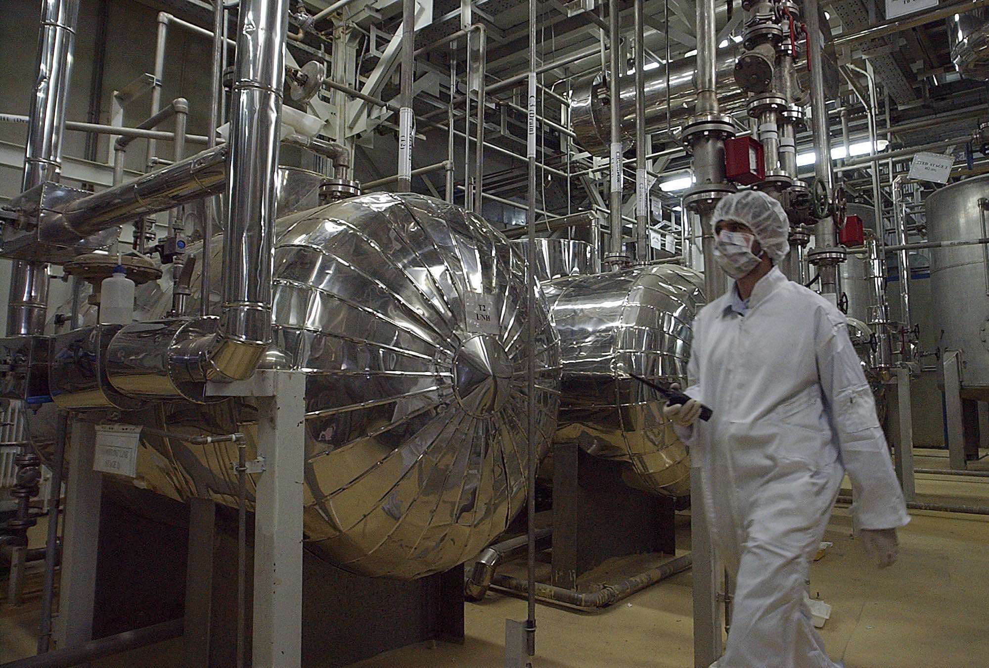  Iranian security official in protective clothing walks through part of the Uranium Conversion Facility just outside the Iranian city of Isfahan