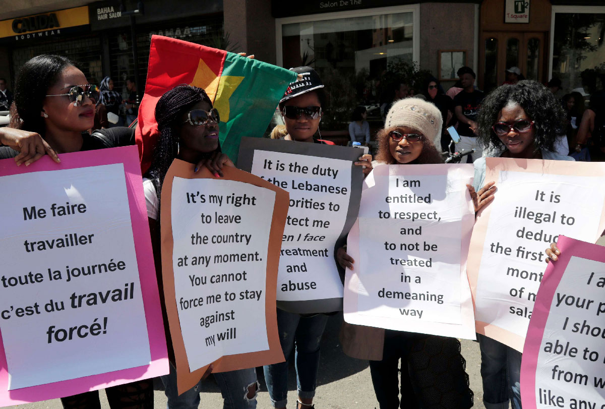 Migrant domestic workers carry placards during a protest in the Lebanese capital Beirut
