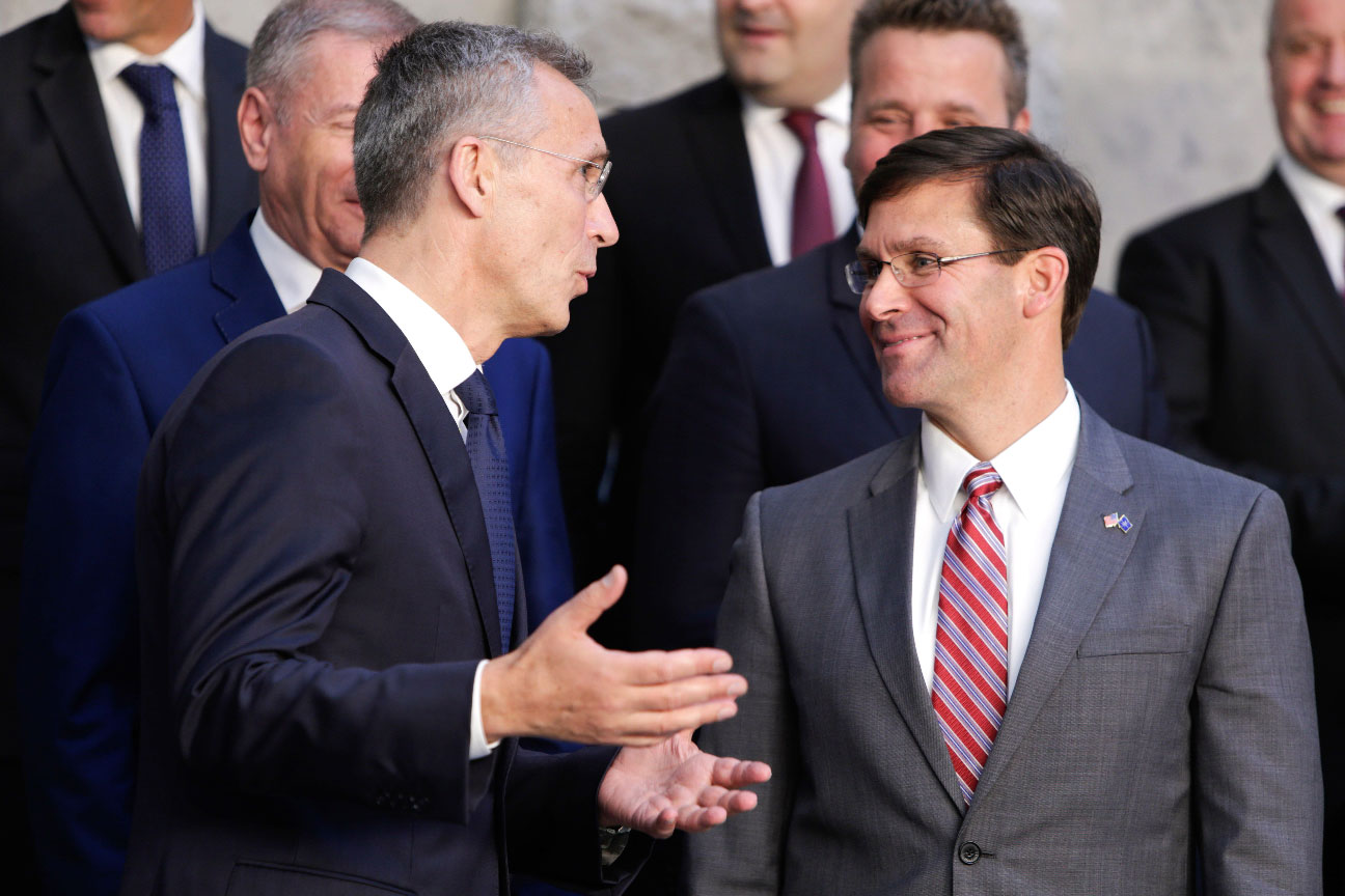 NATO Secretary General Jens Stoltenberg (L) speaks with acting US Secretary for Defense Mark Esper