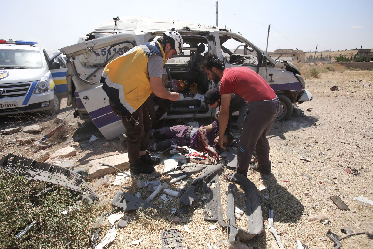 Injured medic receives help after an ambulance was destroyed by a Syrian government air strike