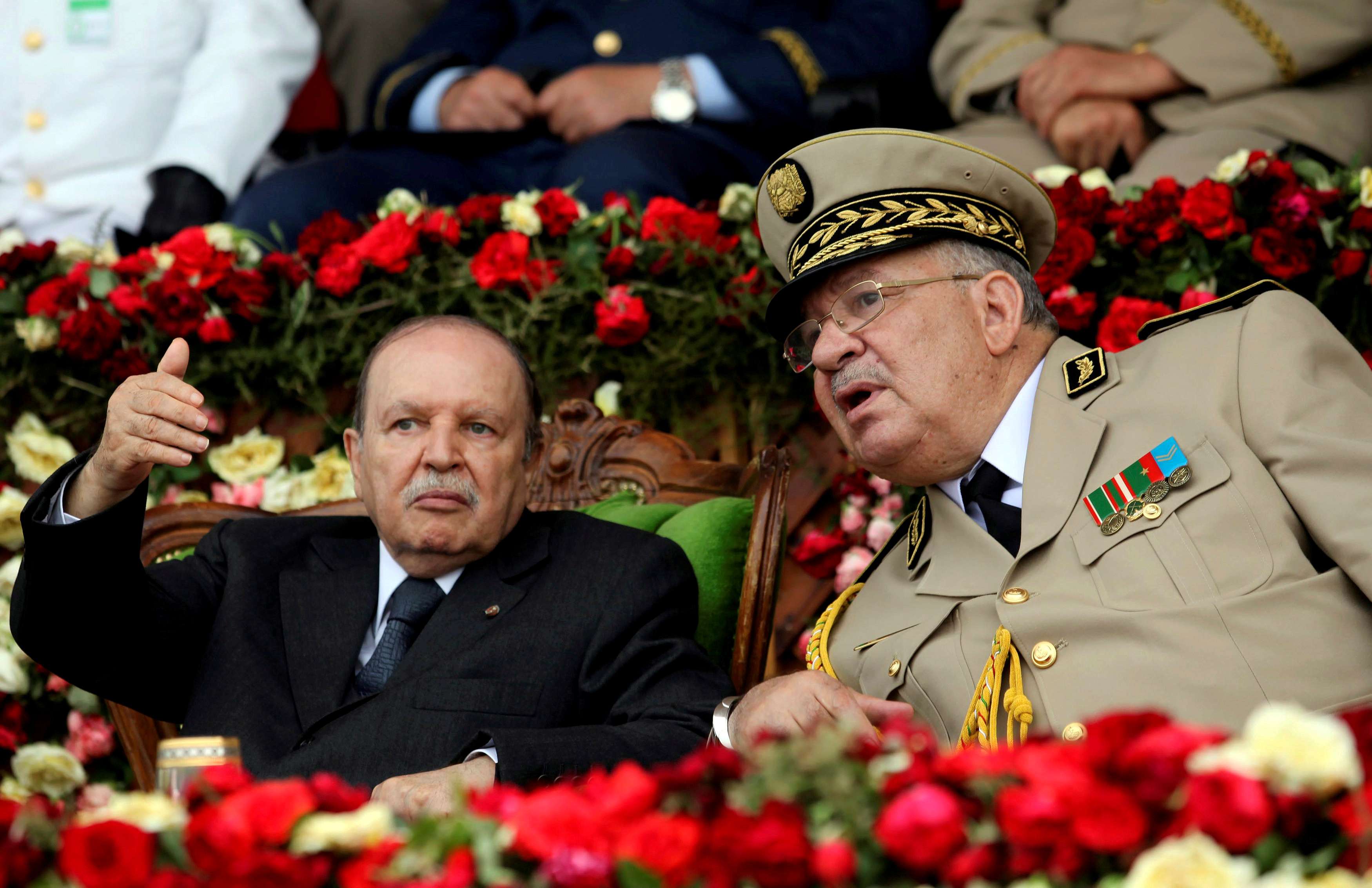 Algeria's President Abdelaziz Bouteflika gestures while talking with Army Chief of Staff General Ahmed Gaed Salah