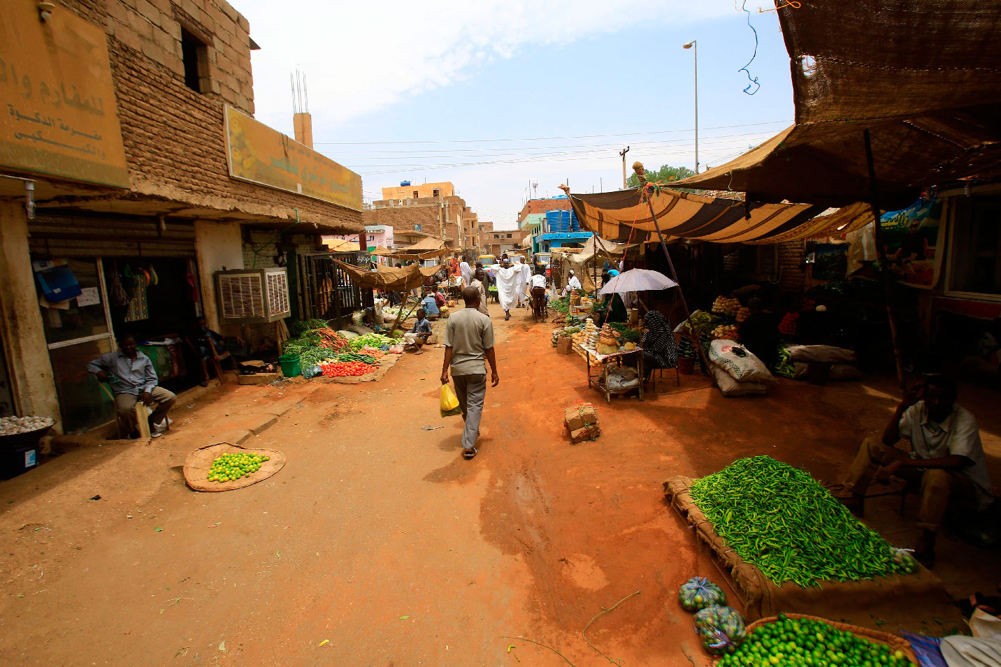 Sudanese residents walk in the central market of Khartoum